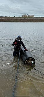 "Diver ready to take cherne blocking plug underwater"